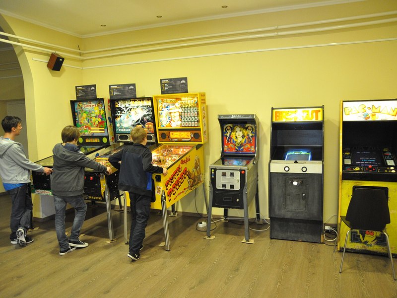Retro arcade play area lined with classic upright cabinets